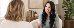 Annette Benedetti speaking with a female client during a private coaching session for bisexual women